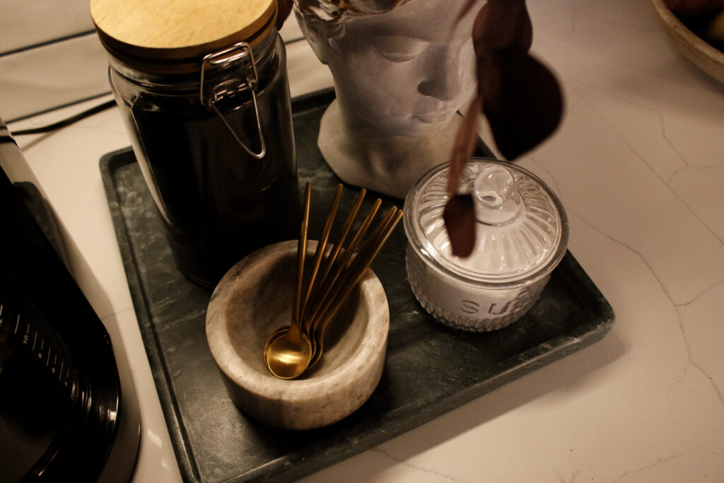 gold spoons and a sugar dish on a coffee bar