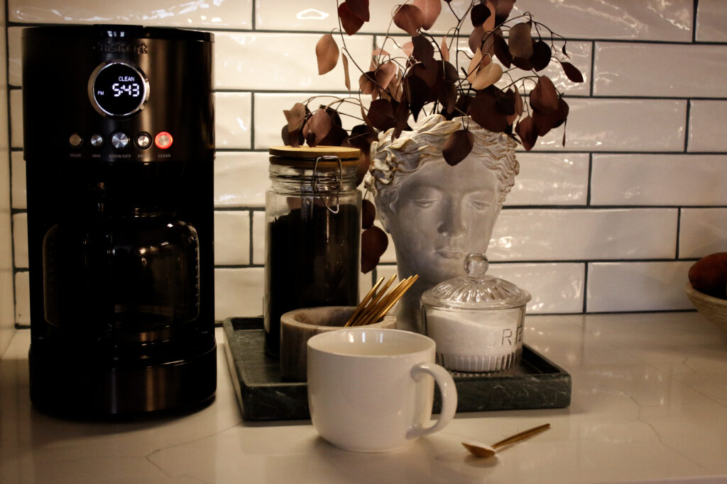 coffe mug next to coffee maker